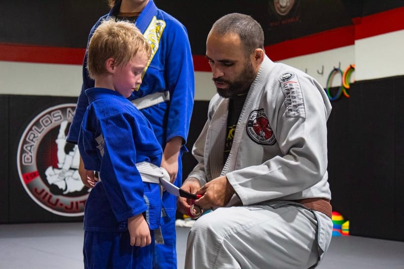 A young student in blue at a belt ceremony